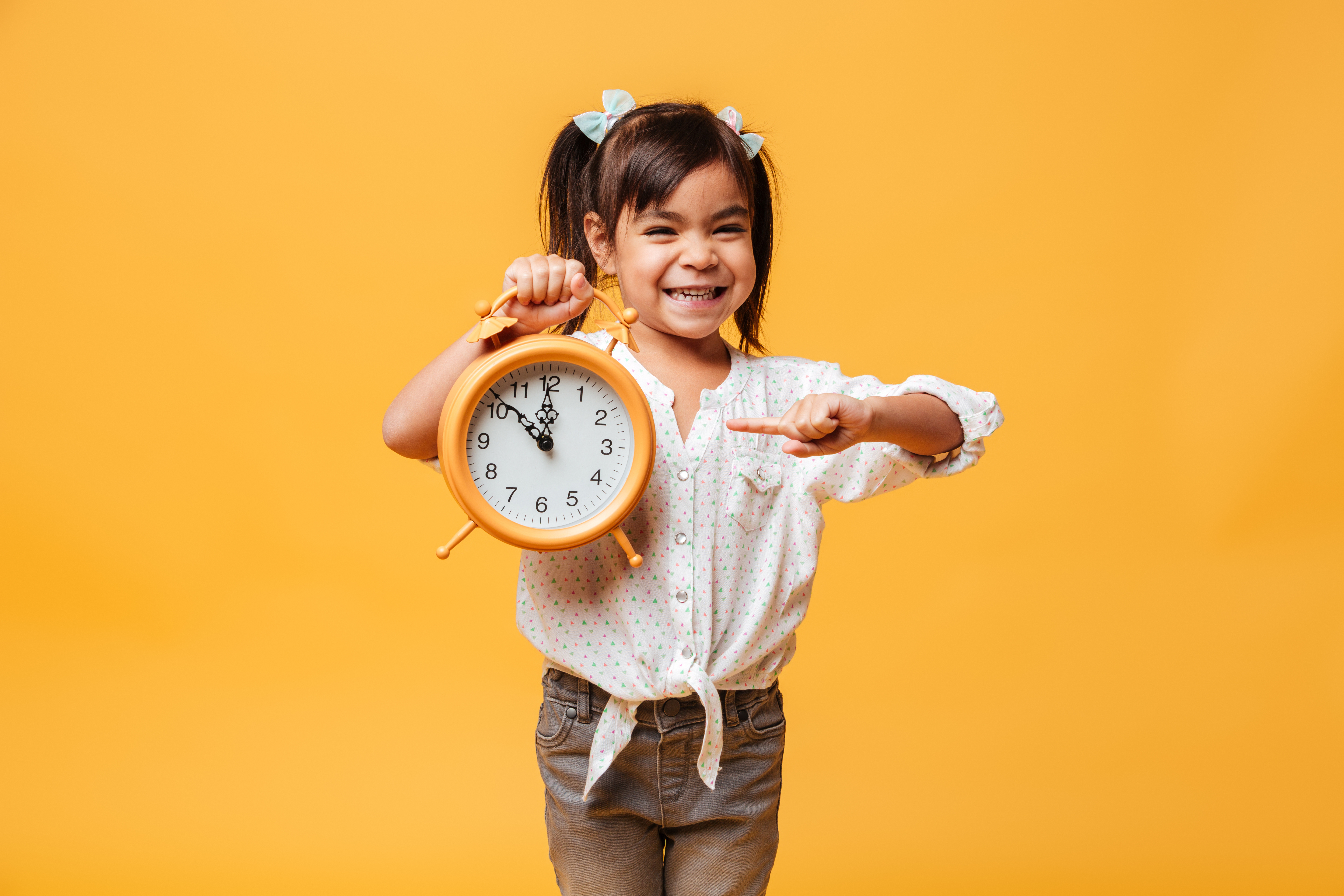 child with a clock